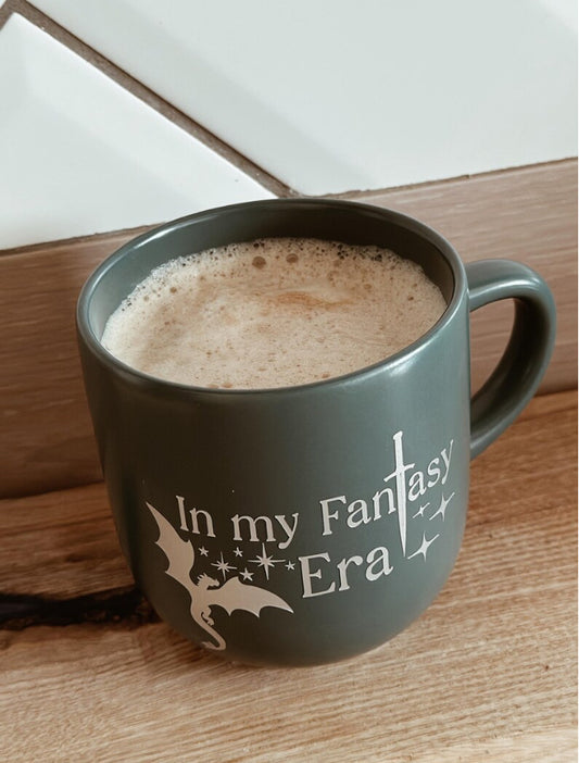 Fantasy-themed book lover’s mug with magical quote design, perfect for readers who enjoy fantasy novels, witches, dragons, and cozy reading sessions.